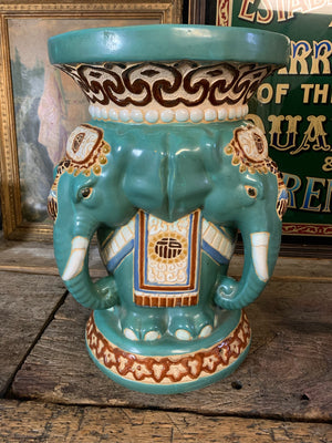 A large ceramic elephant head jardiniere