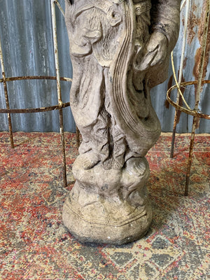 A cast stone garden statue of Guanyin