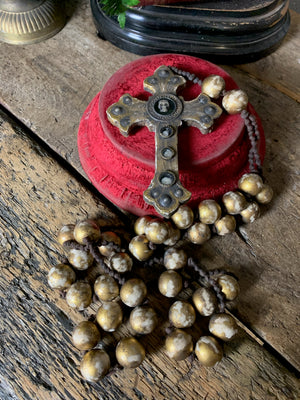 A set of oversized wooden rosary beads with memento mori motif