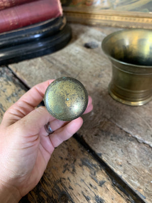 A gilt bronze pestle and mortar