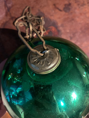 A large green mercury glass witches ball