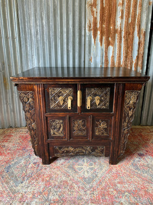 A carved wooden Chinese altar cabinet