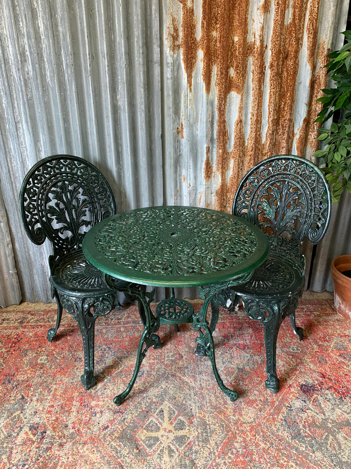 A green garden table and chairs set