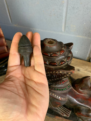 A carved wooden Manussiha sphinx statue