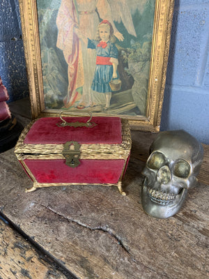 An ornate red velvet casket
