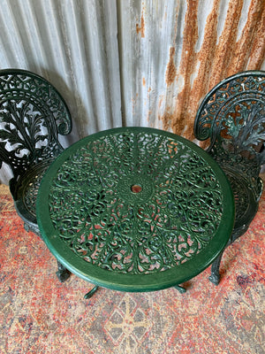 A green garden table and chairs set