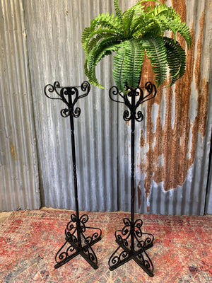 A pair of wrought iron Gothic candlesticks