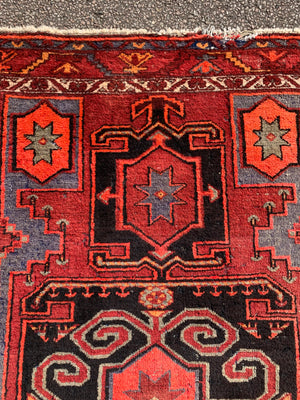 A Turkish red ground rug ~ 211cm x 138cm