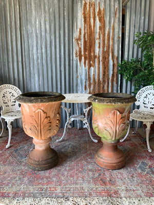 A pair of large terracotta acanthus urns