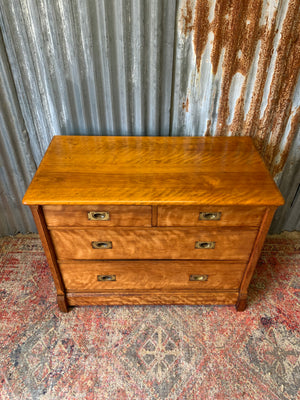 A satinwood chest of drawers