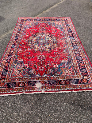 A large red ground Persian rug - 299cm x 194cm