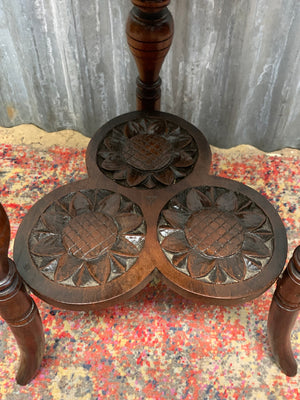 A carved mahogany occasional table with trefoil cloverleaf top