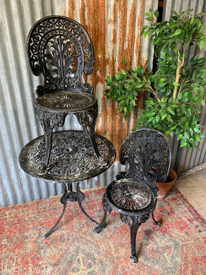 A black garden table and chairs set