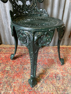 A green garden table and chairs set