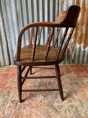 An oak spindle back captain's chair