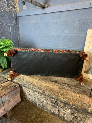 A large kilim-style footstool on cabriole legs