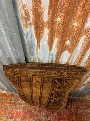 A large golden Persian carpet cushion