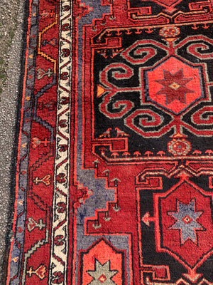 A Turkish red ground rug ~ 211cm x 138cm