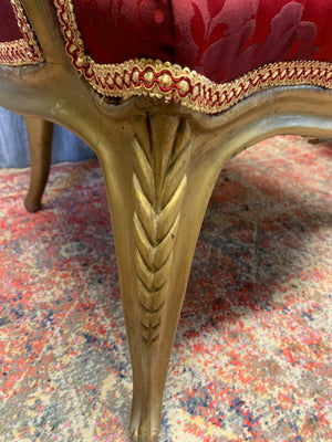 A pair of red damask giltwood open armchairs