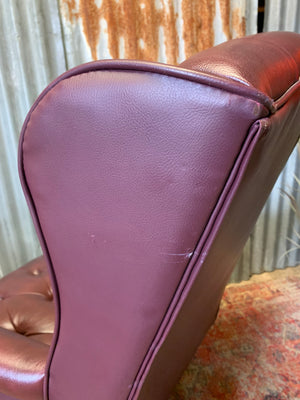 A burgundy leather full button tilt and swivel desk chair