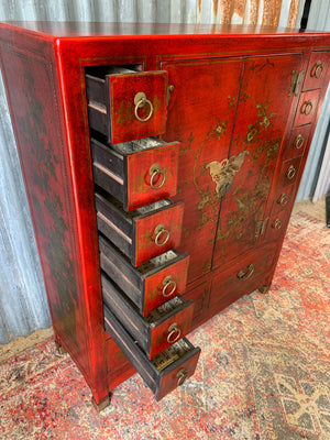 A red and gold lacquered chinoiserie cabinet