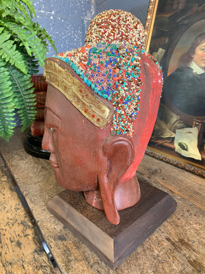 A carved wooden Buddha head