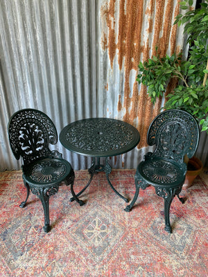 A green garden table and chairs set