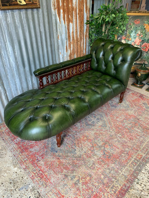 A Victorian-style green leather chaise longue