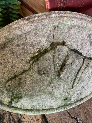 An oval cast stone plaque depicting a dog's head in profile ~C