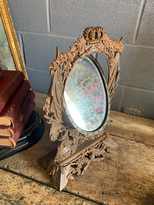 A cast iron table top mirror