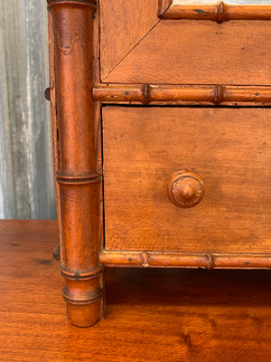 A small French faux bamboo mirrored cabinet