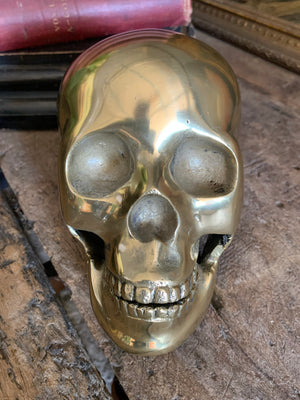 A life-size brass human skull model