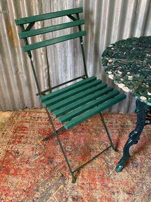 A green garden table and chairs set