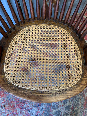 A banker's chair with caned seat