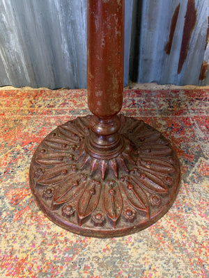 A cast iron bistro table with hand-painted chess board top