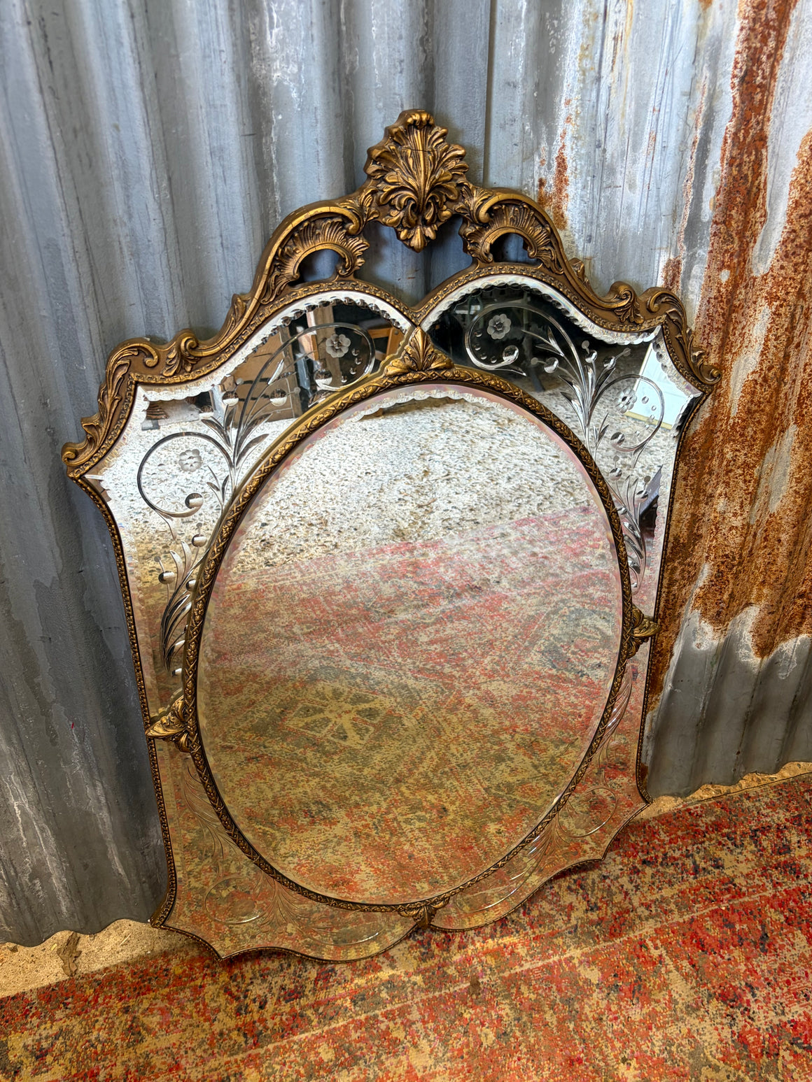 A large Venetian style gilded mirror