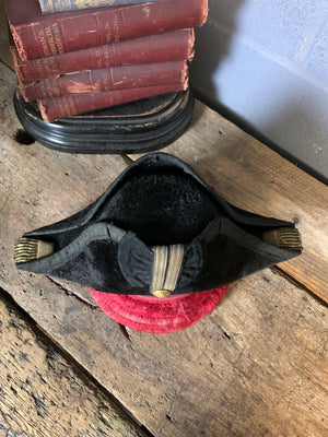 A Royal Navy bicorn hat in monogrammed tin