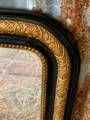 A large French black and gold mirror