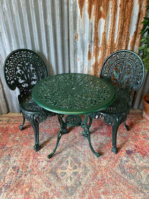 A green garden table and chairs set