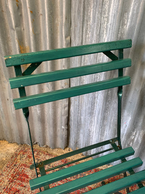A green garden table and chairs set