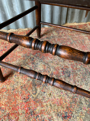 An oak spindle back captain's chair