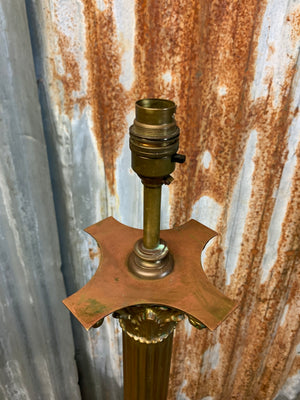 A brass Corinthian column standard lamp on lion paw feet