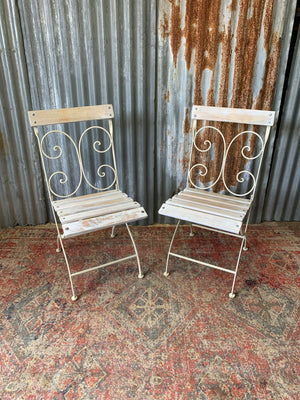 A white garden table and chairs set