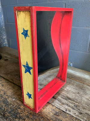 A wooden fairground distortion mirror - red, yellow or blue