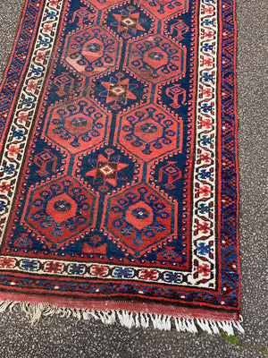 A long red ground blue Persian runner rug ~ 304cm x 104cm