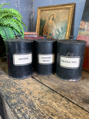 A set of three lidded wooden apothecary jars