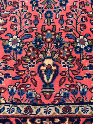 A Persian pink ground wool rug ~ 155cm x 105cm