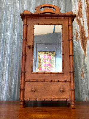 A small French faux bamboo mirrored cabinet