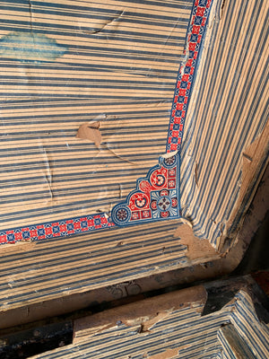 An oak dome top steamer trunk with tooled leather motifs