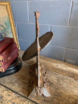 A cast iron table top mirror